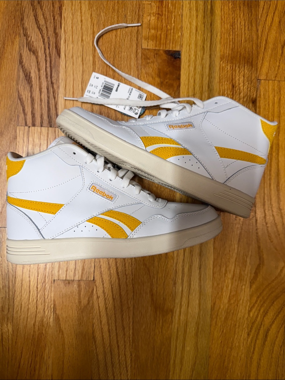 Reebok White High-Top Sneakers with Yellow Stripes